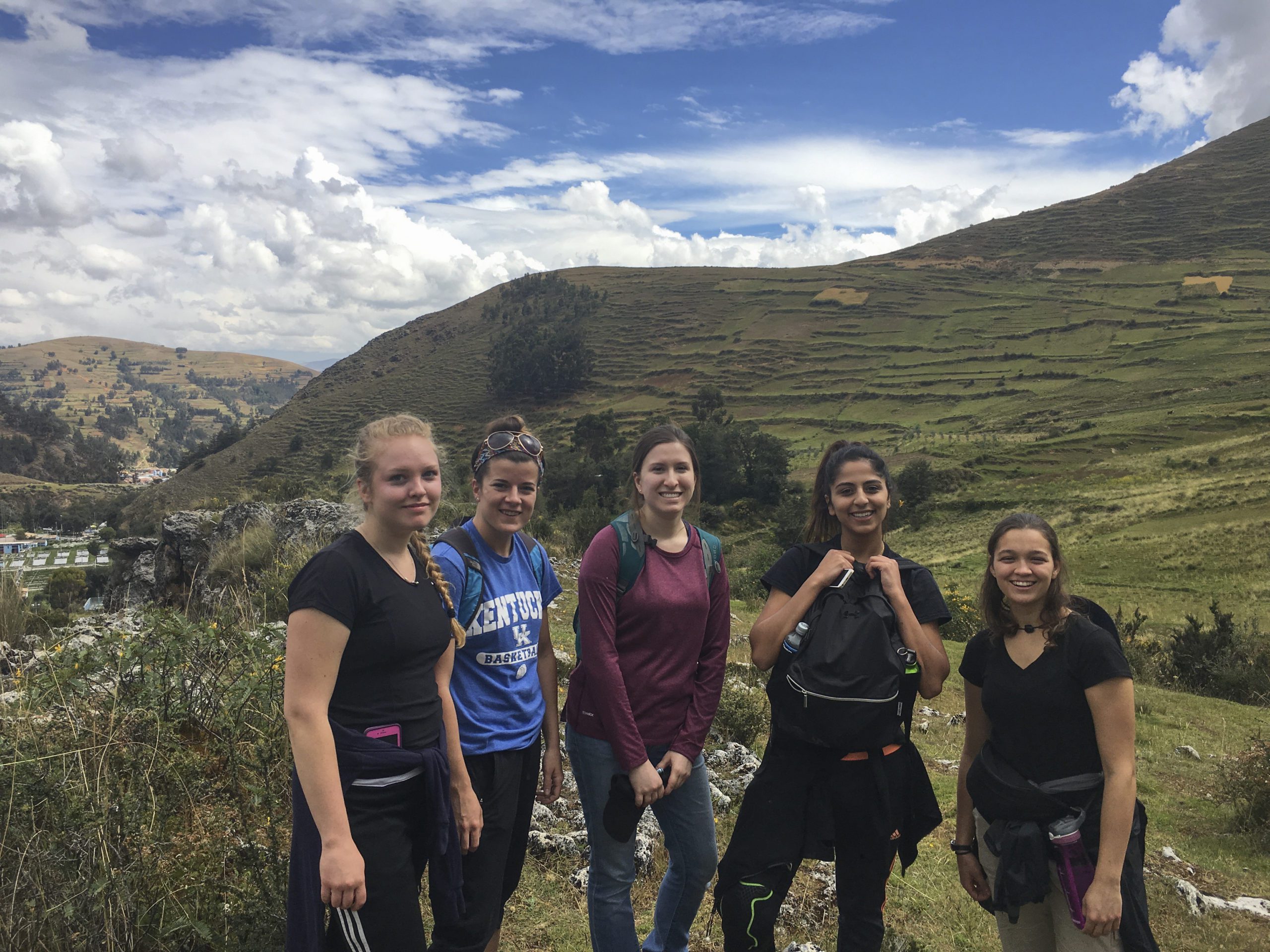 Students with Peru hilly landscape behind