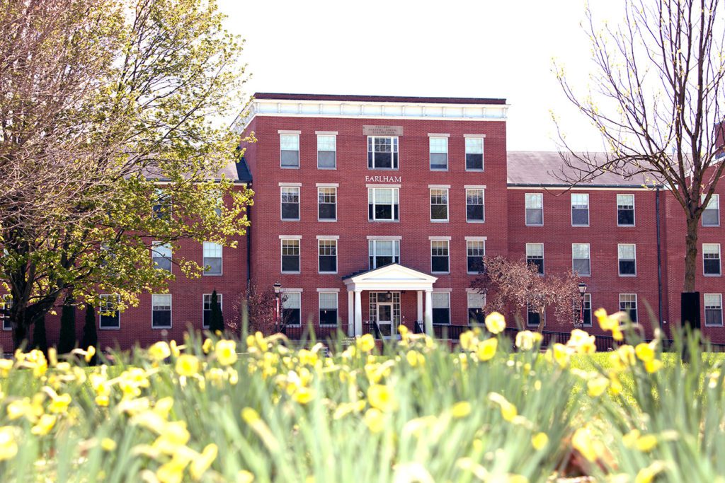 Photo of the front of Earlham Hall with beautiful spring flowers