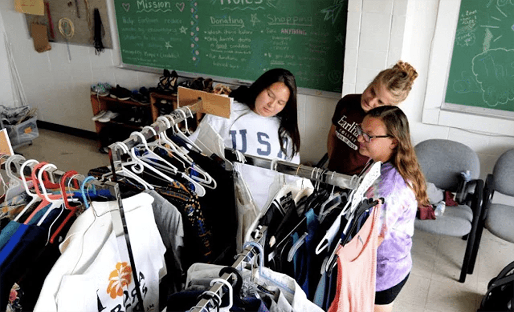 Earlham students looking through clothing in the free store