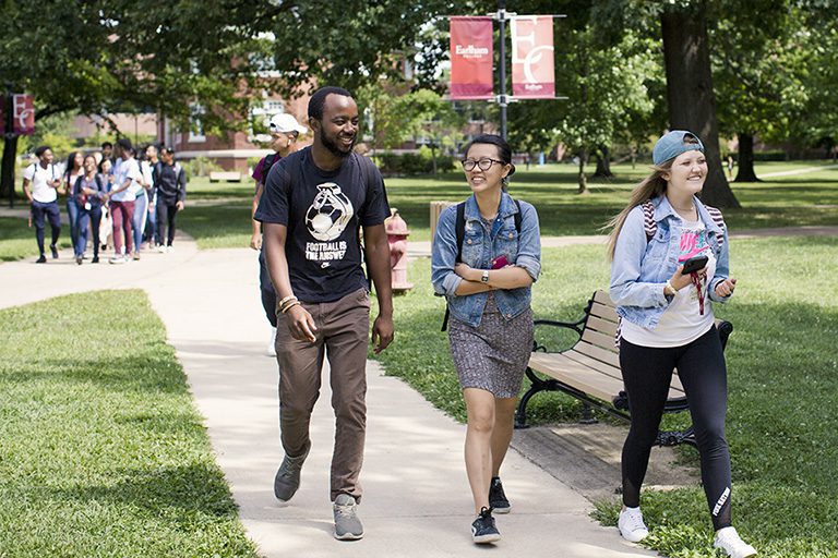 Students walking down the sidewalk of The Heart of campus