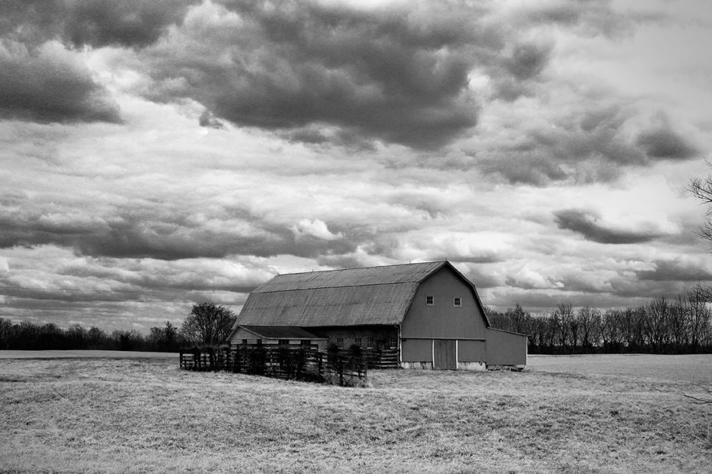 black & white of barn in prairie on a cloudy overcast day