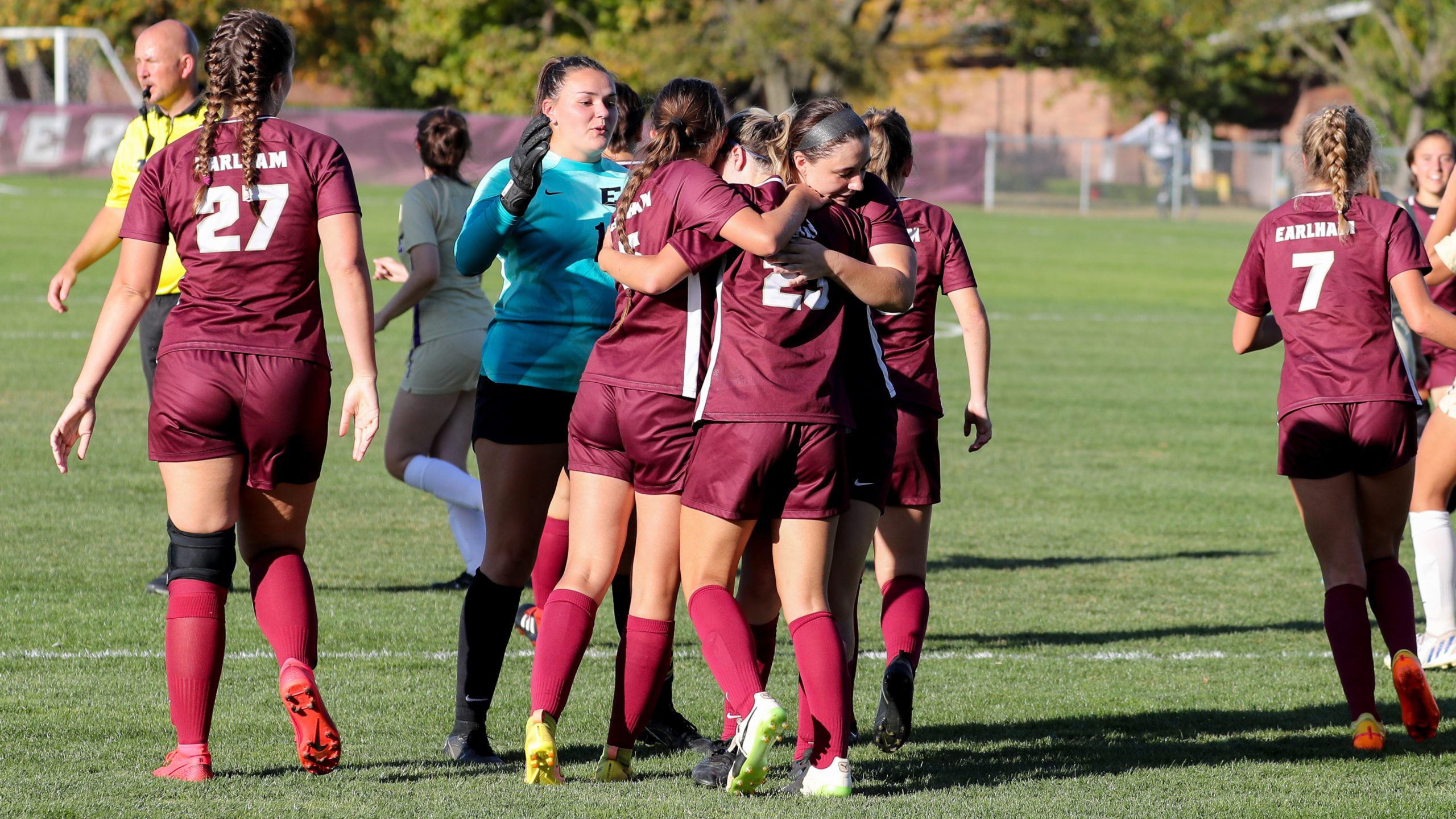 Women's soccer team celebrates a goal. 