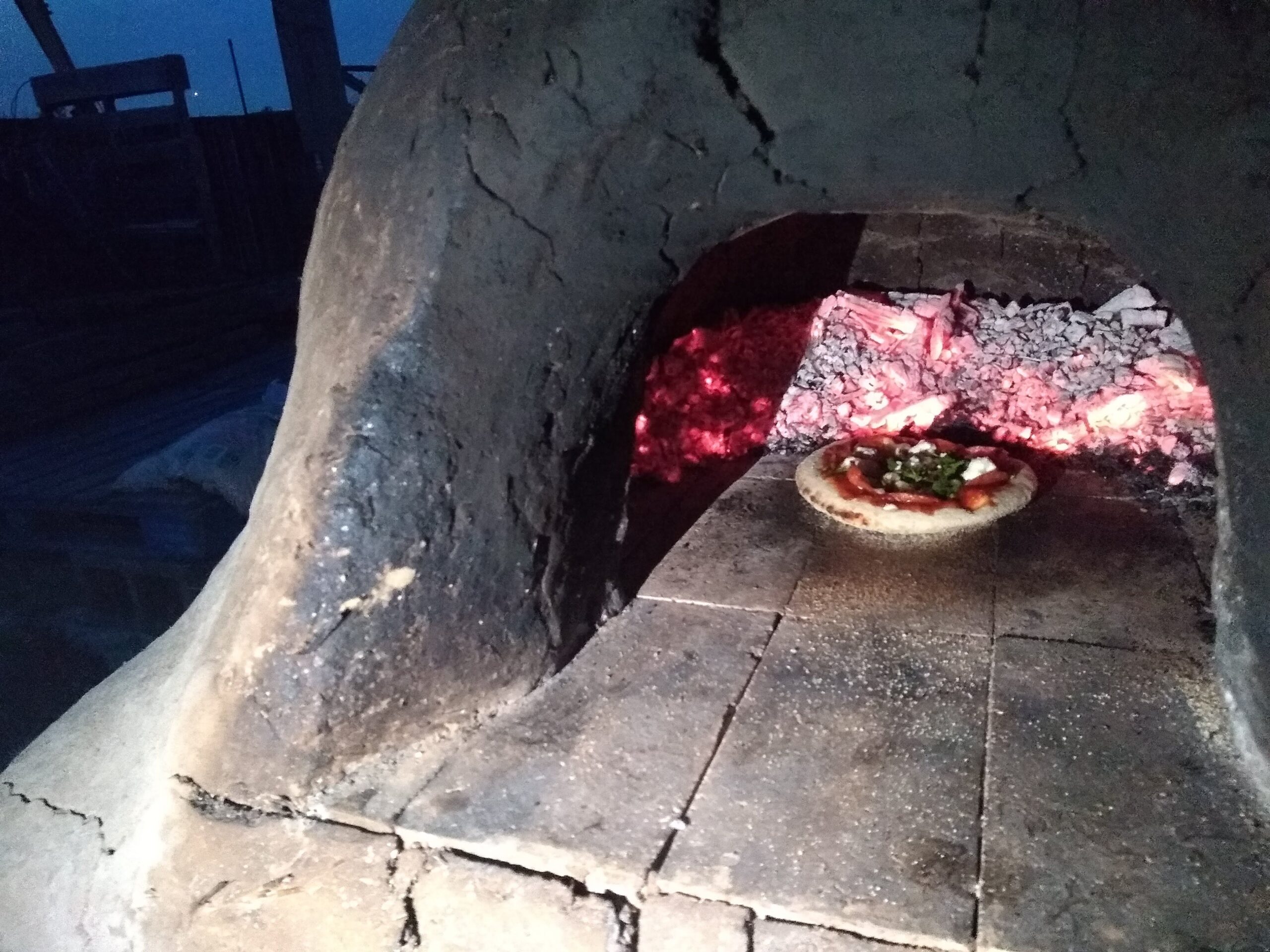 Pizza oven at Miller Farm with a pizza inside 