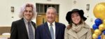 Reece Axel-Adams, a blonde masculine person with pink streaks in his hair, poses with Democratic Lt. Governor candidate Terry Goodin at the Madison County Democratic Party Annual Big Blue Banquet. From left to right - Reece Axel-Adams, Terry Goodin (D), and Hazel Vernon.