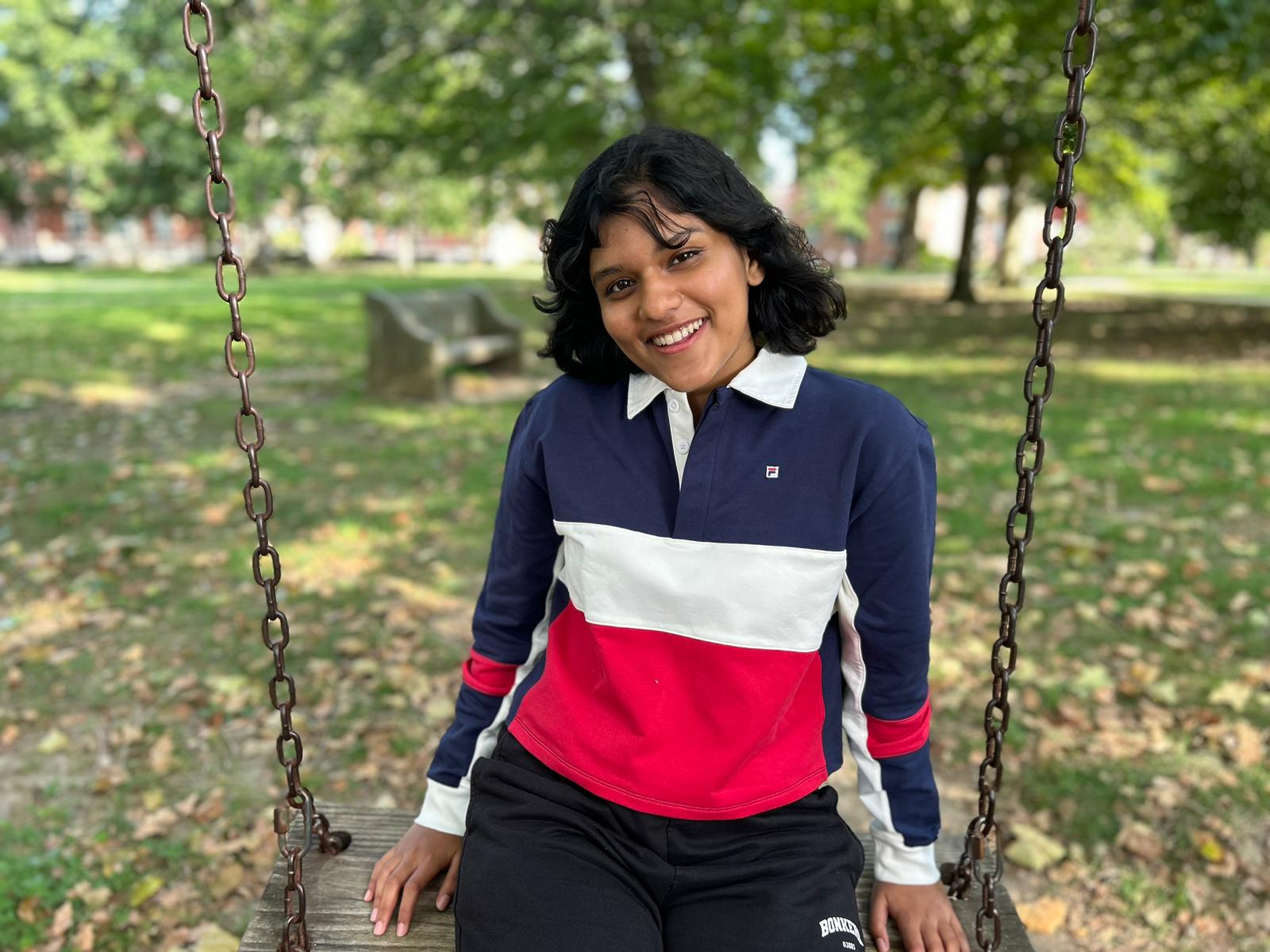 Christine Johnson sitting on a swing in the heart