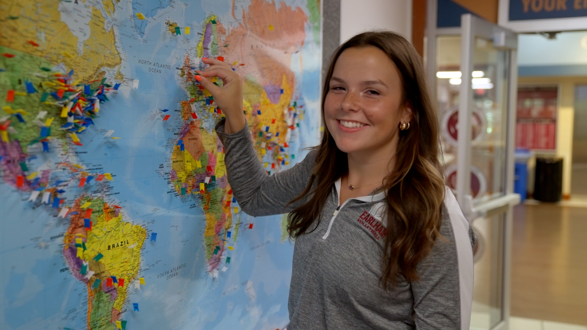 Skyler Murray placing a pin on the world map