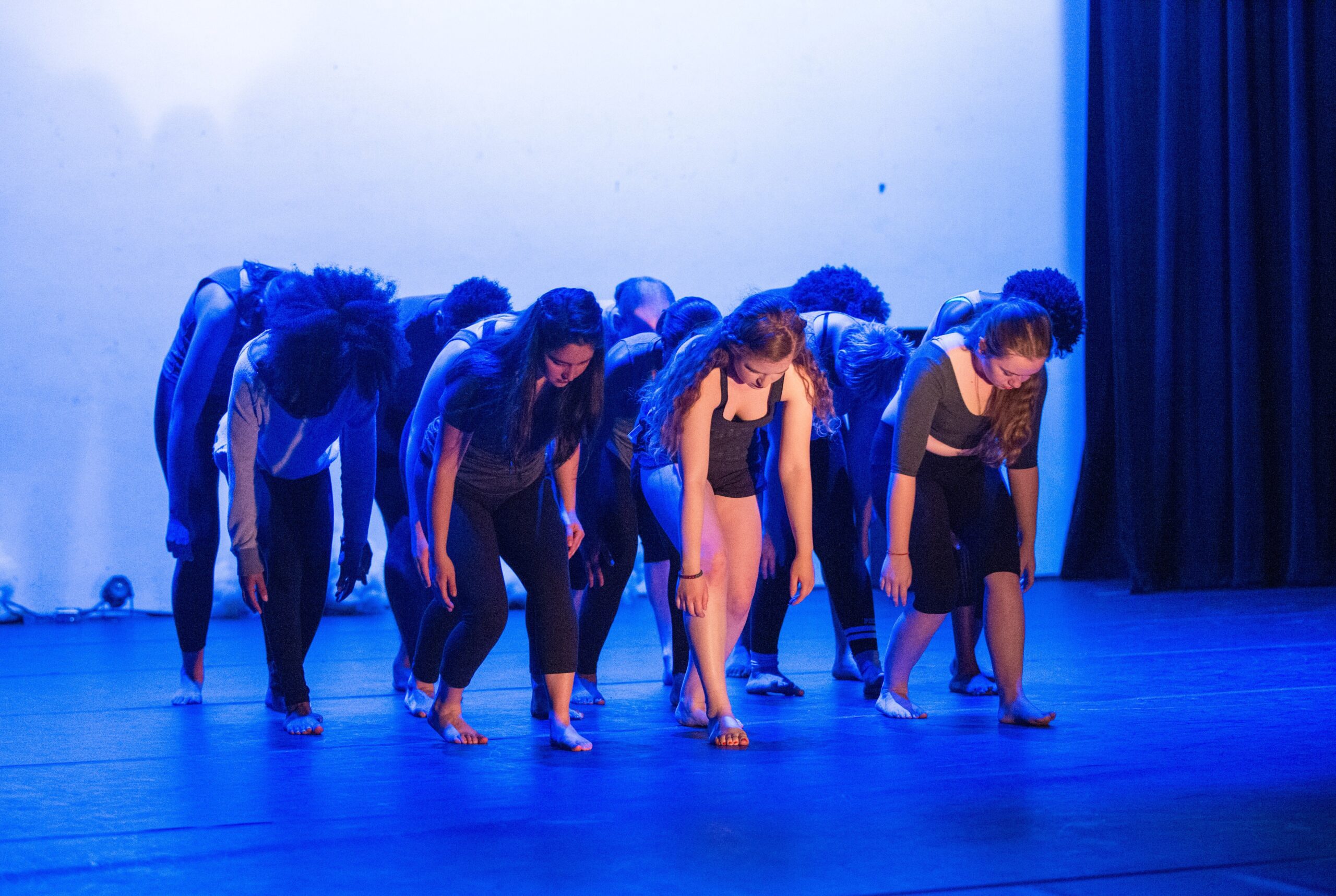 Members of the Earlham Dance Alloy team on stage in their favorite sports uniform