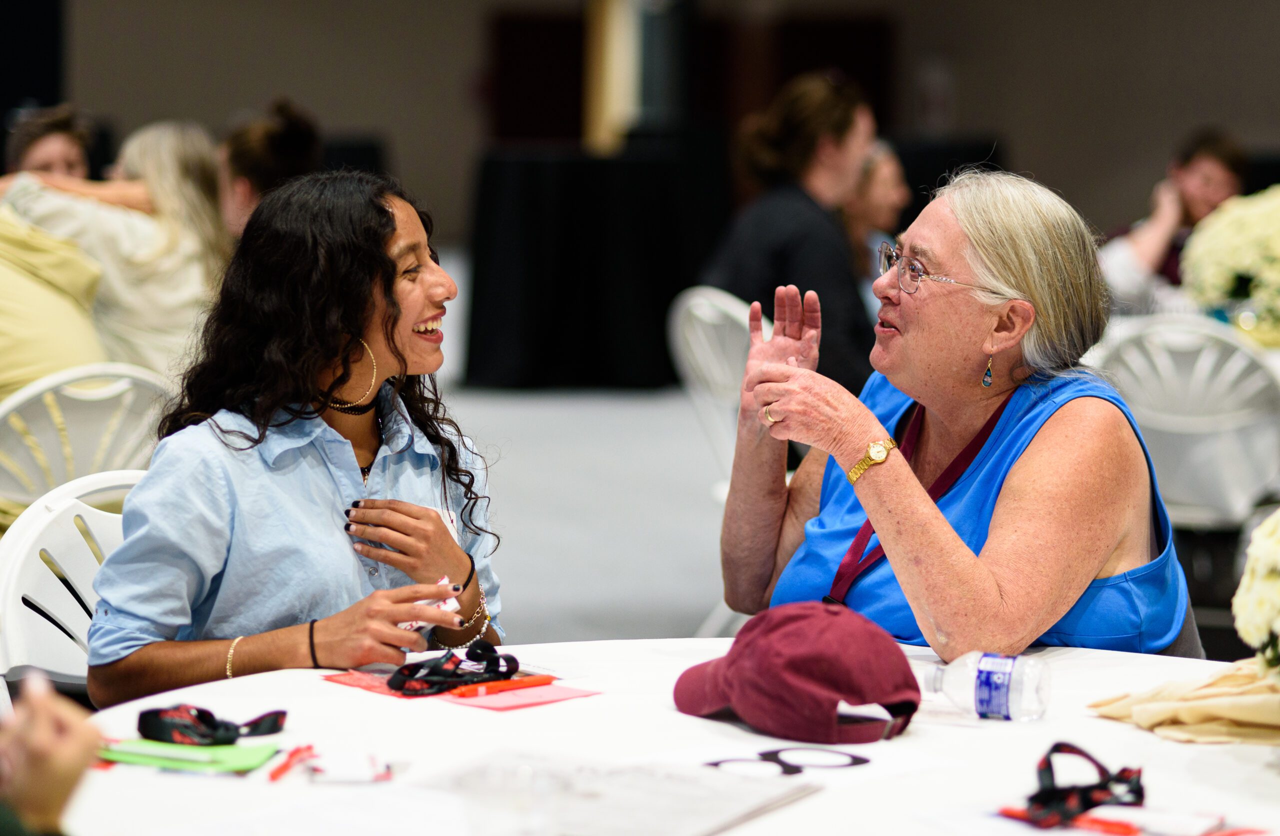 An alumni talking with a student at homecoming