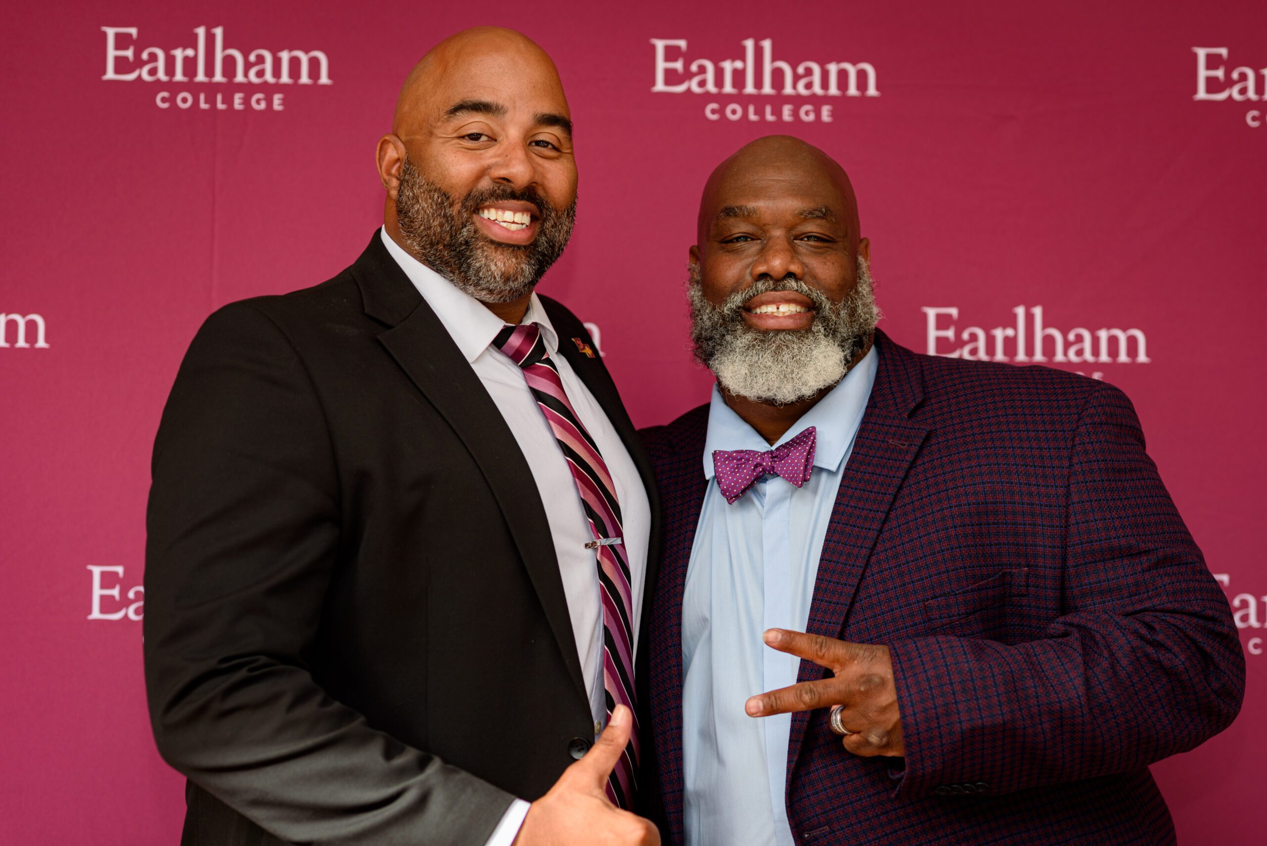 An alumni talking with a student at homecoming