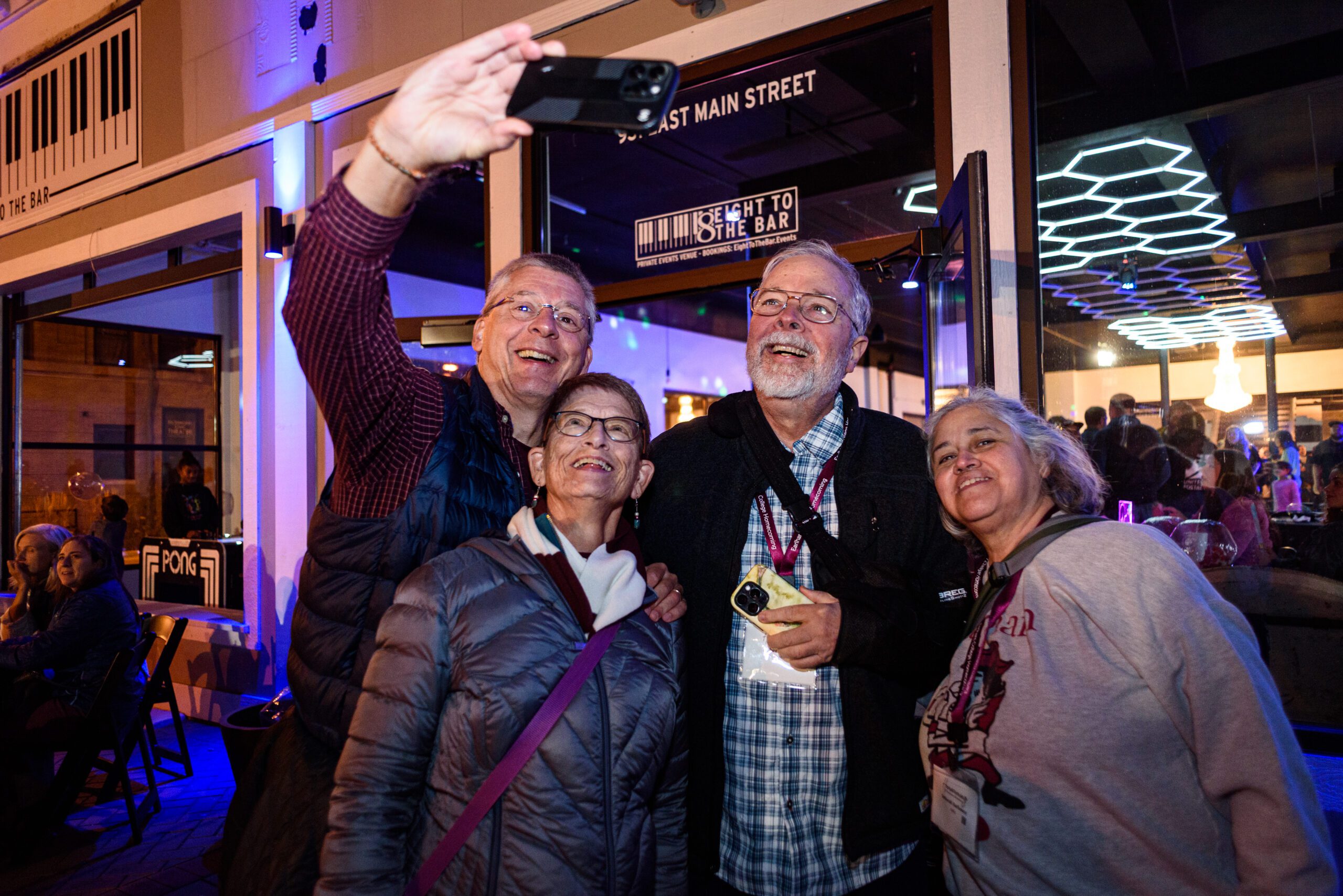 An alumni talking with a student at homecoming