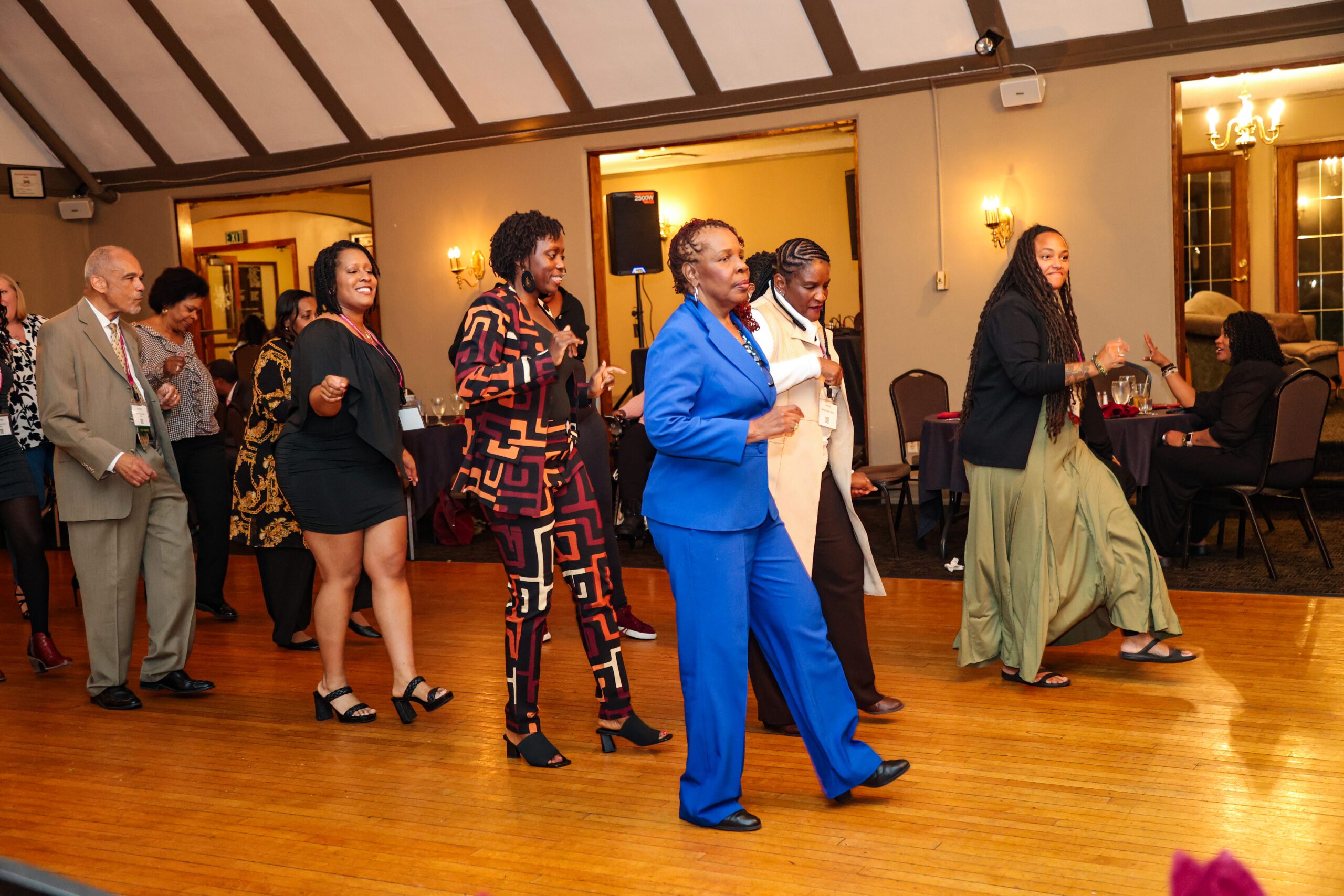 An alumni talking with a student at homecoming