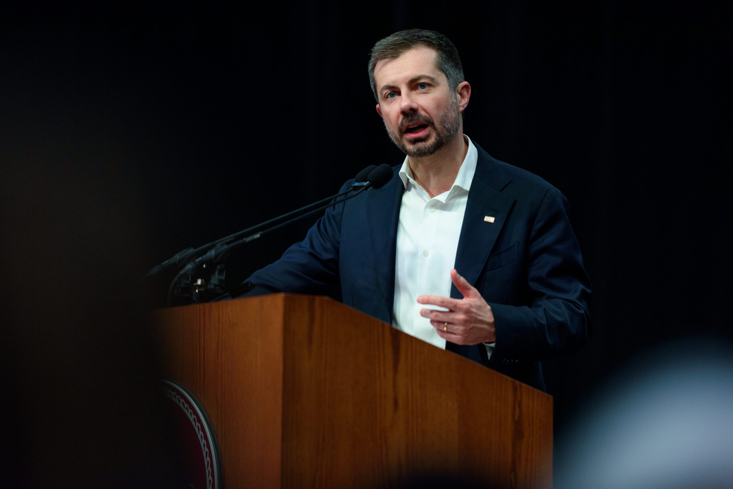 Pete Buttigieg stands and speaks at a podium