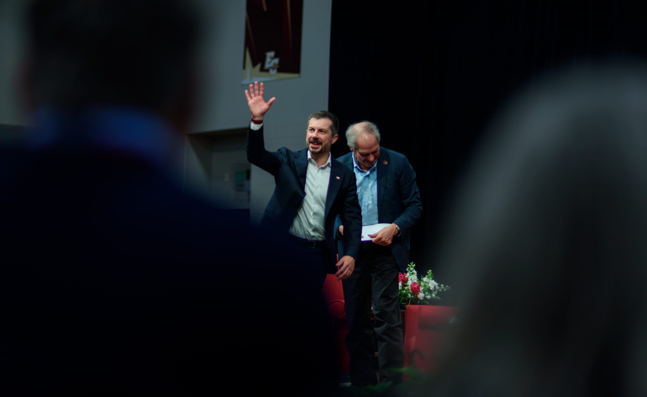 Pete Buttigieg waves to the crowd with Paul Sniegowski close behind him