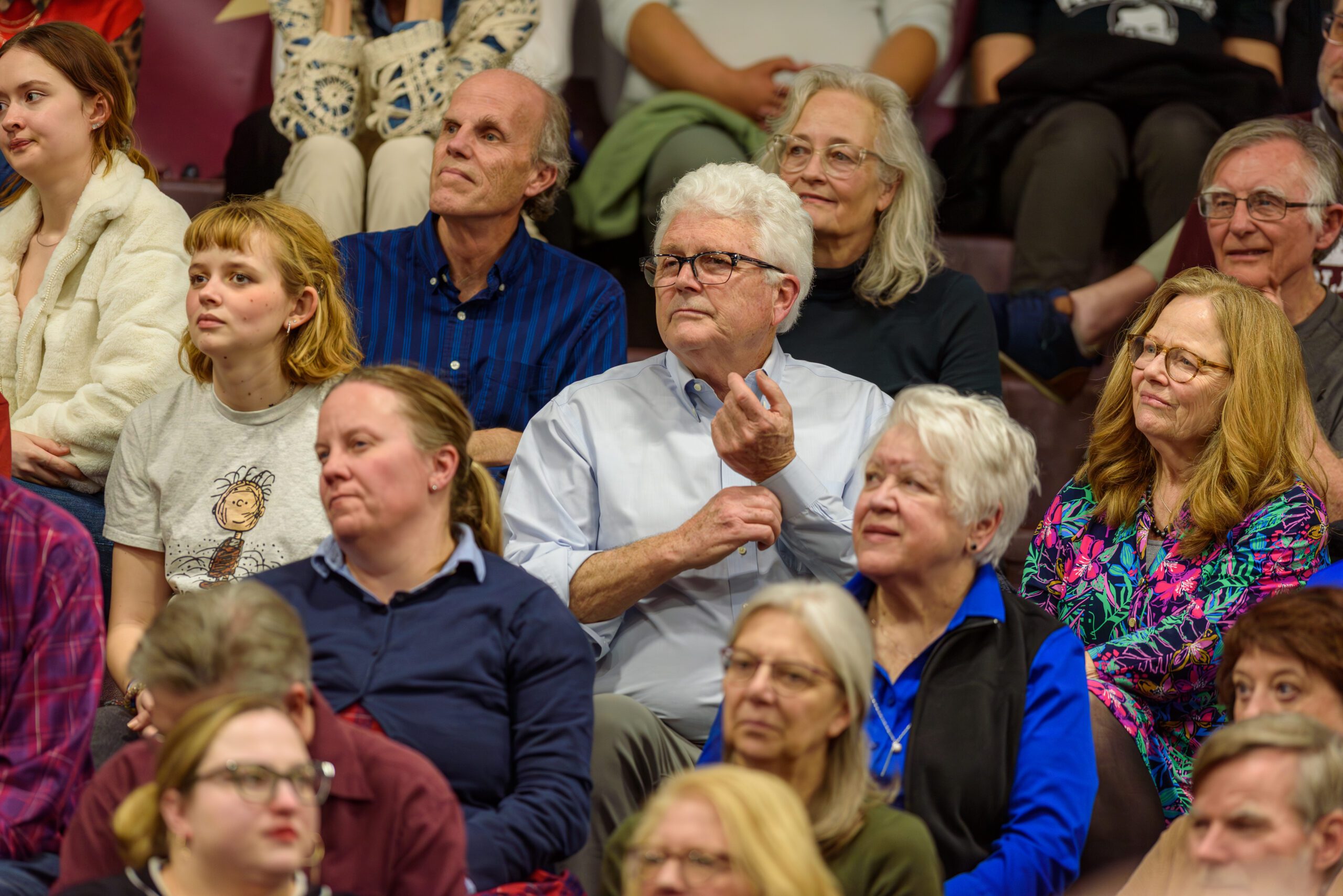 A close up of members of the audience listening to Pete Buttigieg speak
