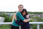 Ashley Jennings, left, and Christine John, right, embrace each other on an overlook in Cincinnati