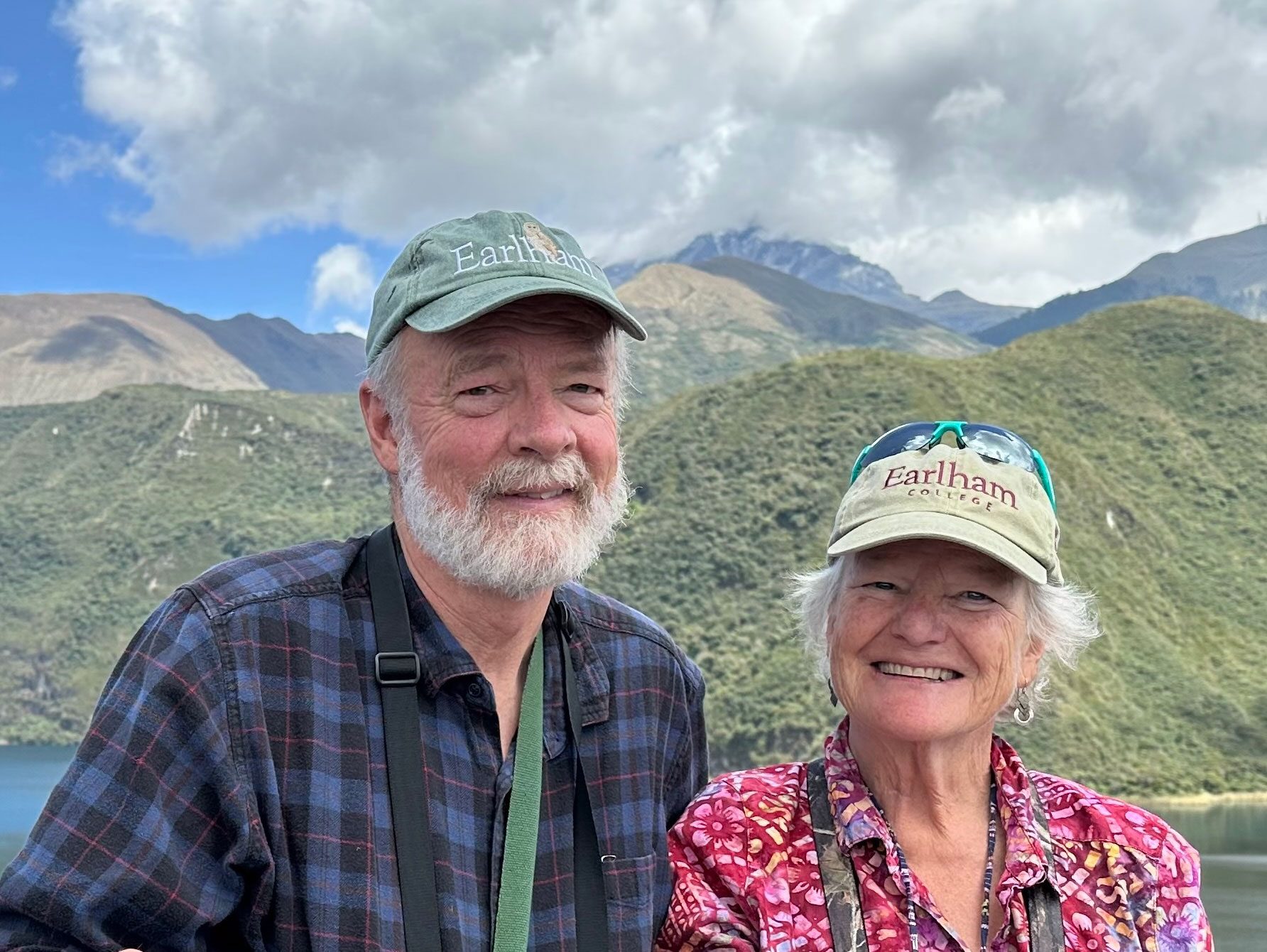 Brent Smith and Nancy Taylor smiling in front of a beautiful mountain vista.
