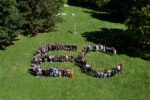 An aerial view of students from the Class of 2030 lined up in the shape of a giant E and C.