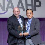 Mike Deibel, pictured left, is presented with an award with the logo of the National Association of Advisors for the Health Professions.