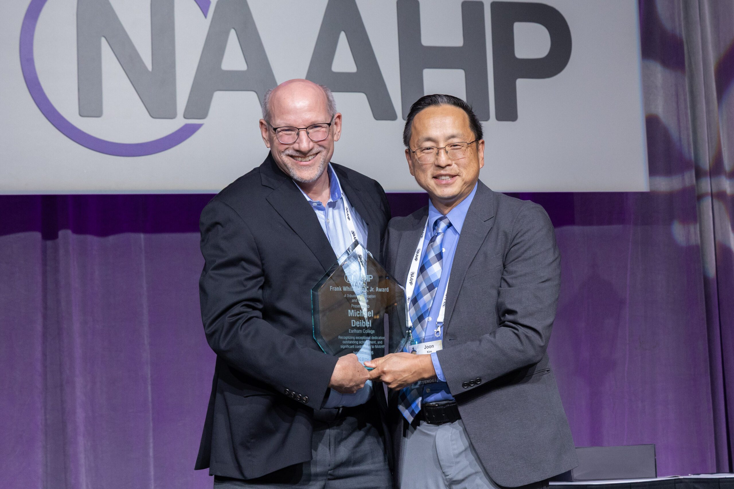 Mike Deibel, pictured left, is presented with an award with the logo of the National Association of Advisors for the Health Professions.